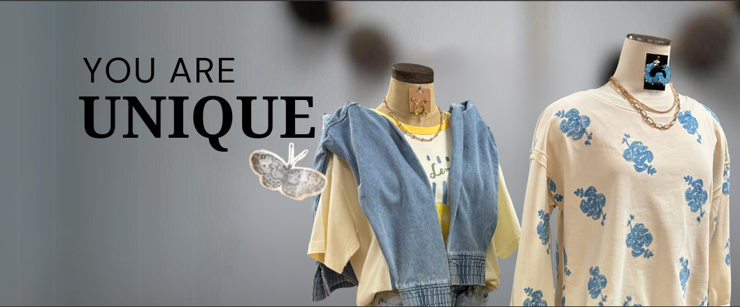 Two mannequins wearing clothing with text 'YOU ARE UNIQUE' on a gray background